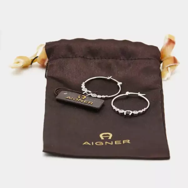 серьги кольца от Aigner, выполненные из серебристого металла.