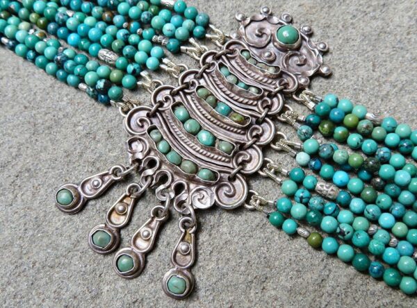 Bracelet with 10 strands of turquoise beads.
